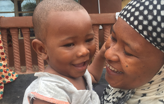 image of african mother holding a happy baby