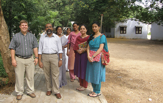 Peter Ferren (far left) visits a school in India where he helped establish school-based mental health services.