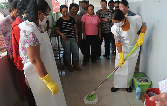 Staff at a Cambodian hospital get training in mixing proper cleaning solutions and in sanitizing the facility.