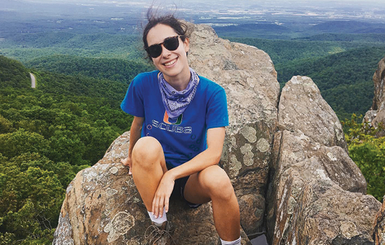 image of mariah landry sitting on top of a mountain