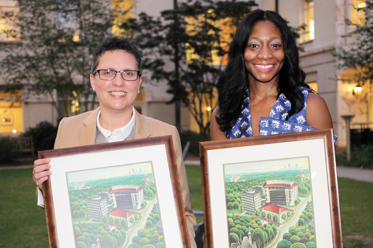 Lisa M. Carlson and Fatima Cody Stanford posing with their Distinguished Achievement Awards.