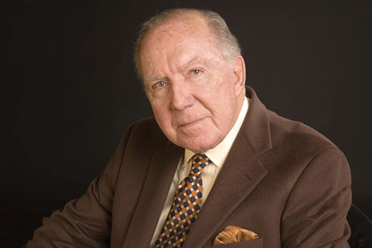 A portrait of Dr. Charles R. Hatcher Jr. in a brown suit