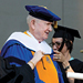 Randall Rollins wearing his cap and gown and receiving honorary degree at emory university in 2015.
